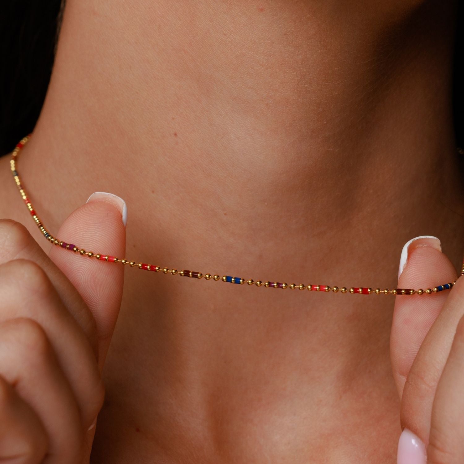 Gold Bahia Necklace Held in Hand